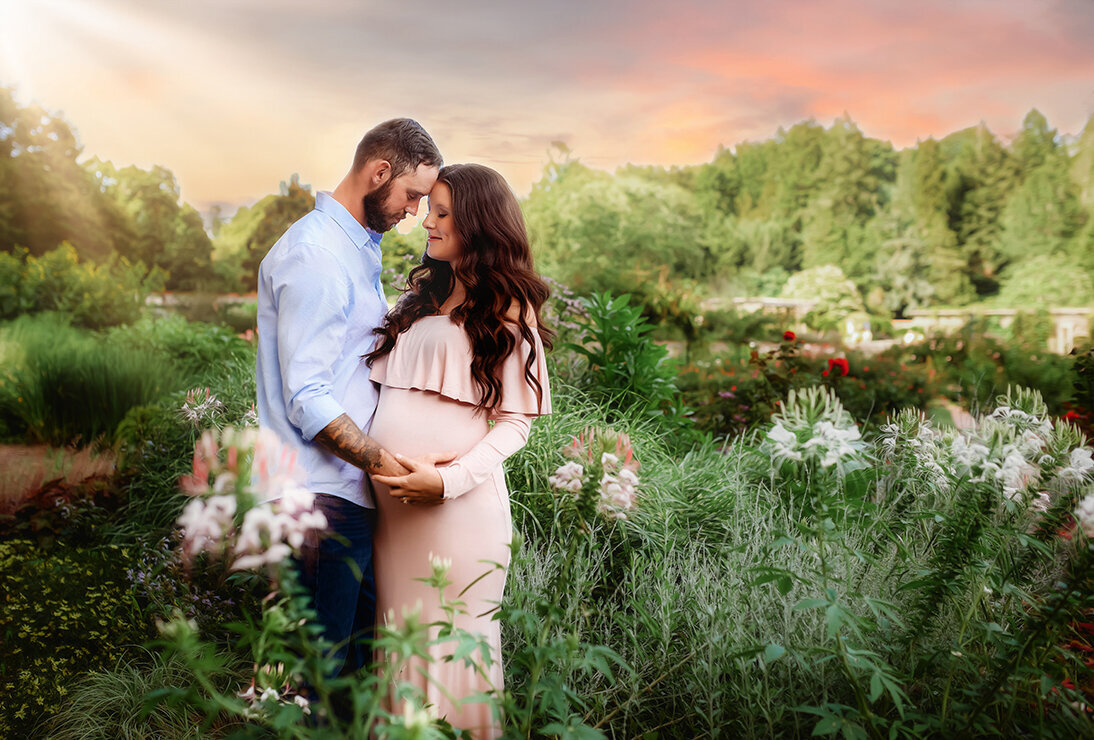 Expectant parents pose for Maternity Portraits  in a beautiful garden at Biltmore Estate in Asheville, NC.
