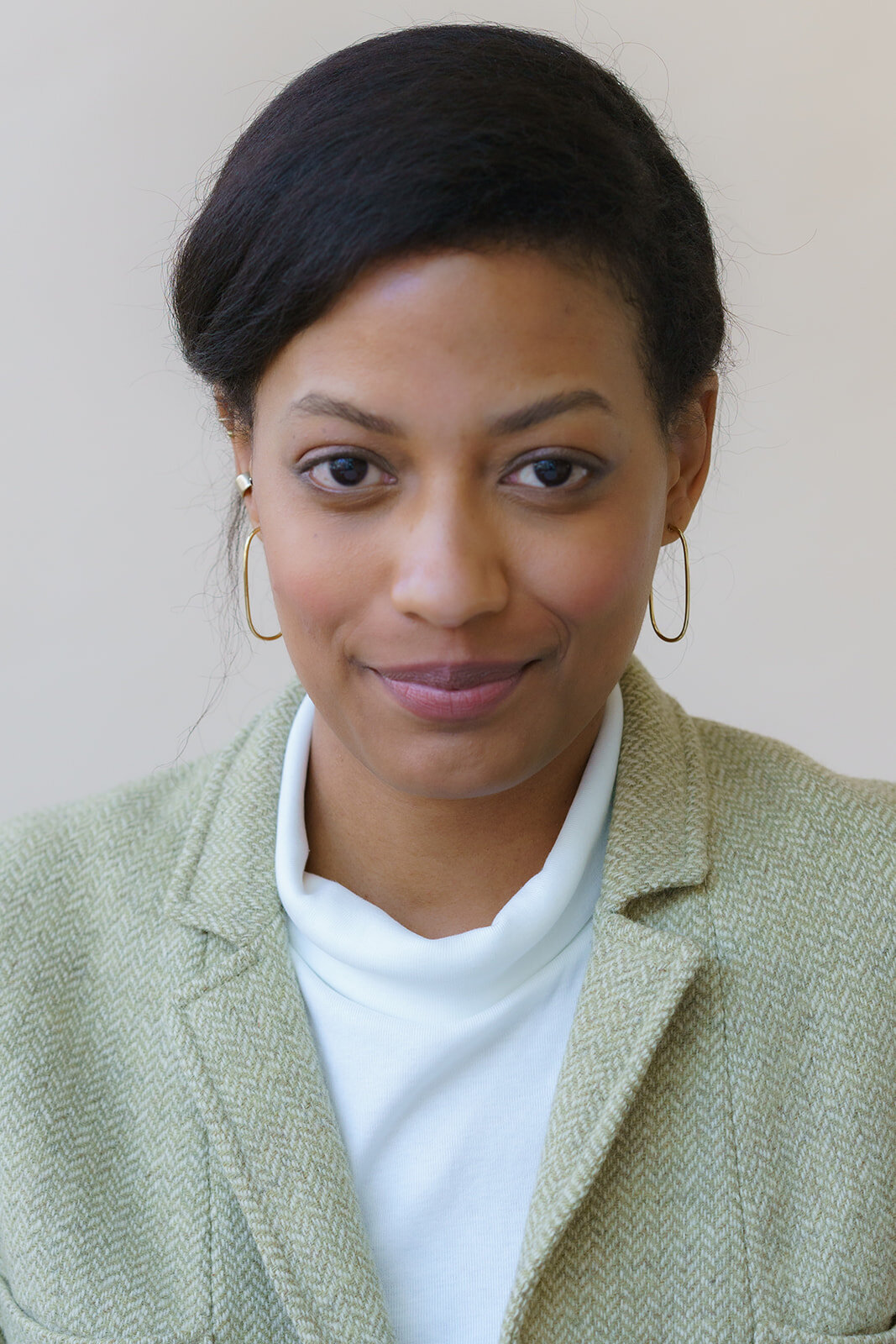 Close-up of an African-American woman in a professional suit smiling 