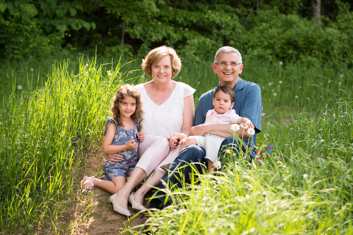grandma and grandpa holding their grandchildren during a family session captured by Ottawa Family Photographer JEMMAN Photography