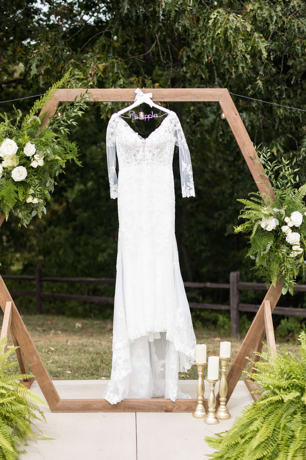 wedding dress hanging from hexagon wedding centerpiece