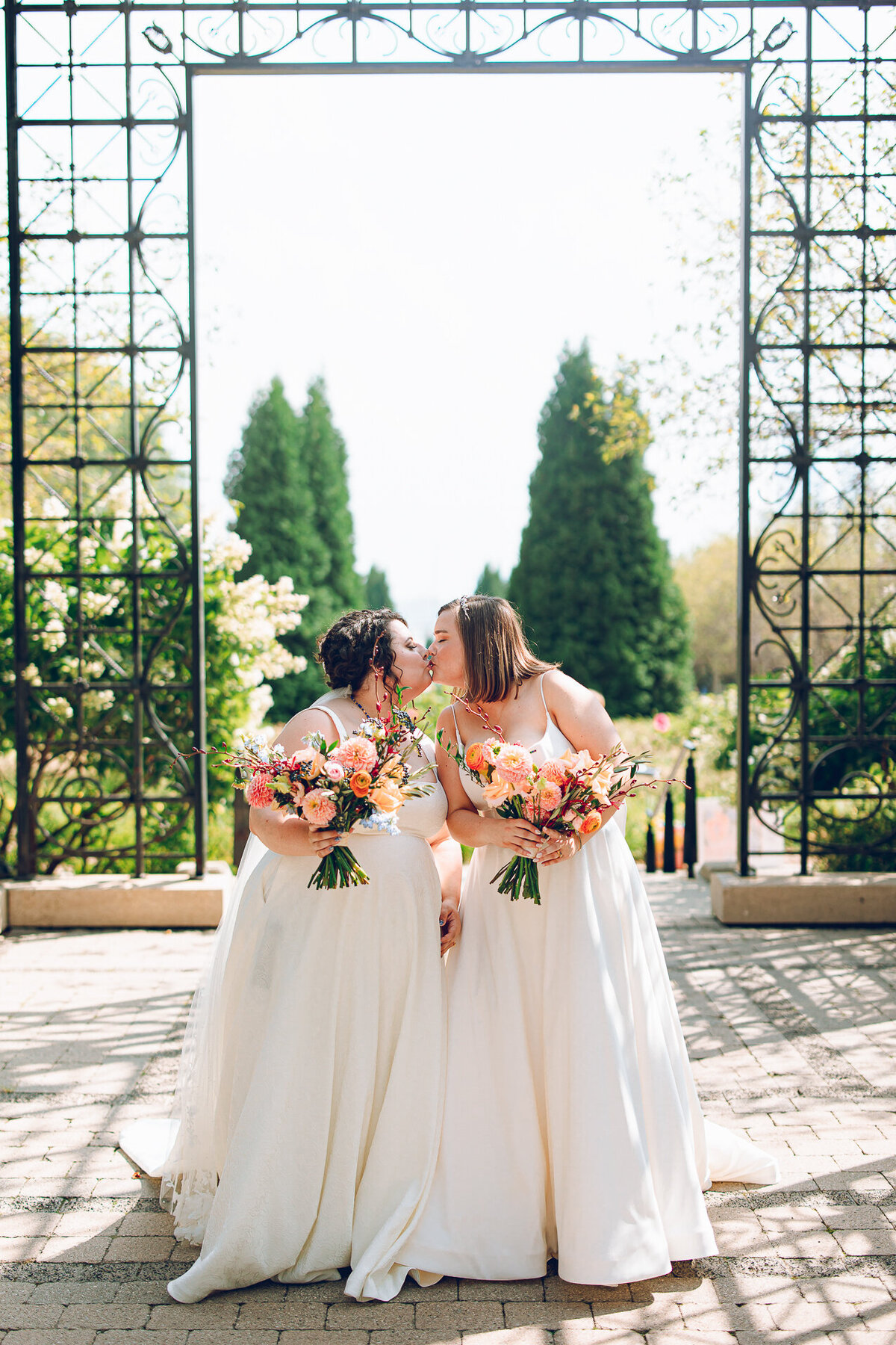 A queer couple poses for their wedding at the Cancer Survivors Garden at Maggie Daley Park