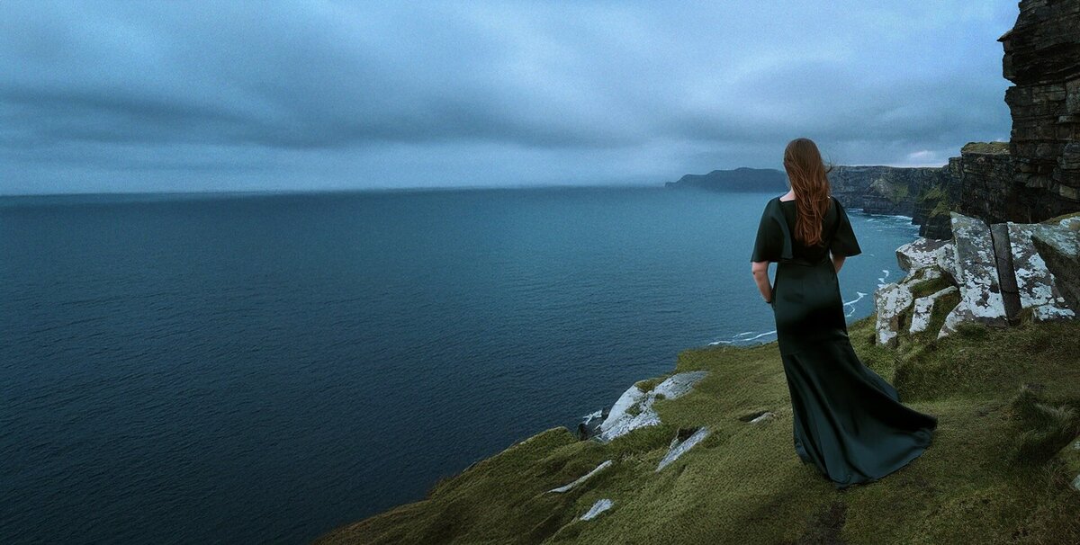 Woman Standing on Cliffs of Moher