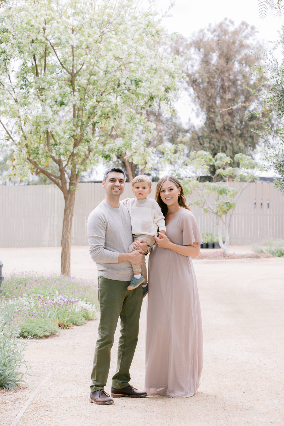 Two parents smiling with their child in between them