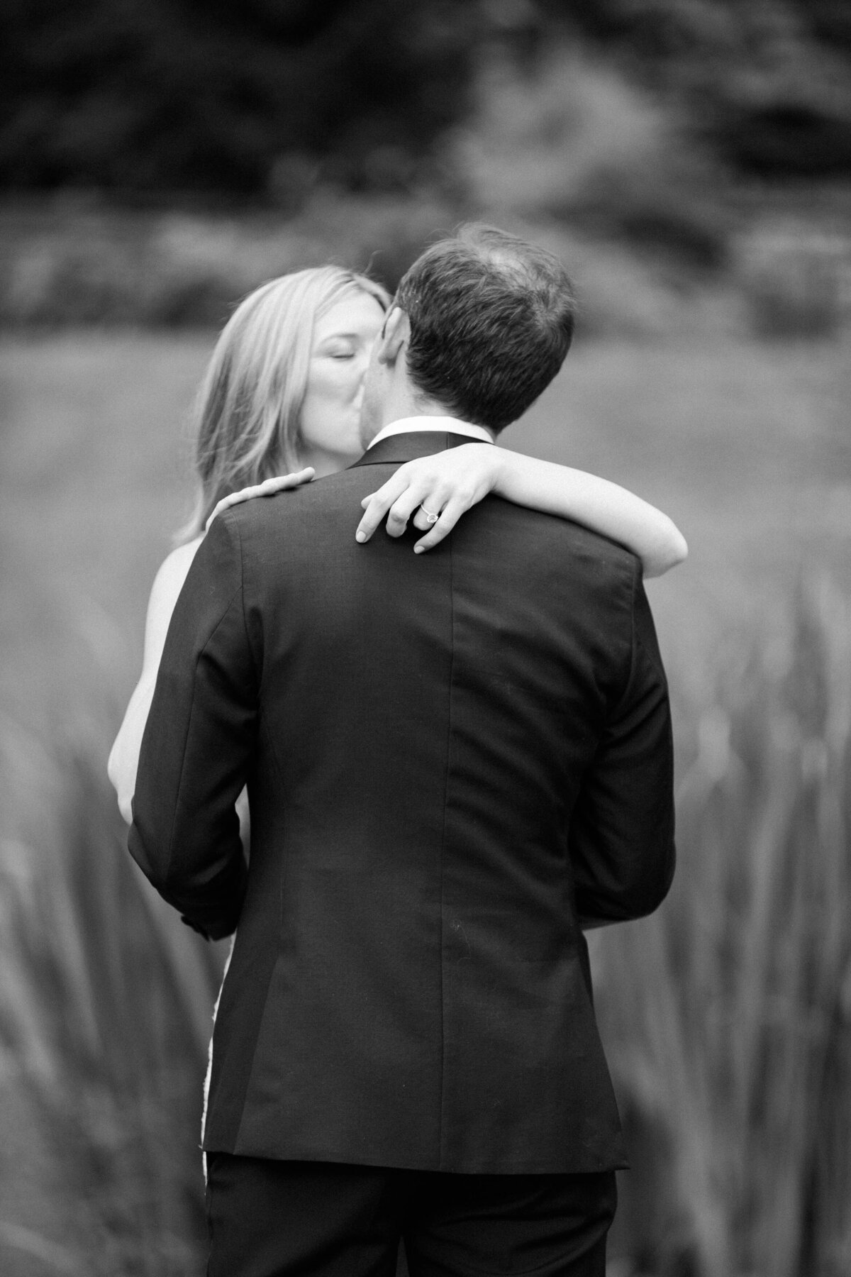 Newlyweds kiss privately while embracing 