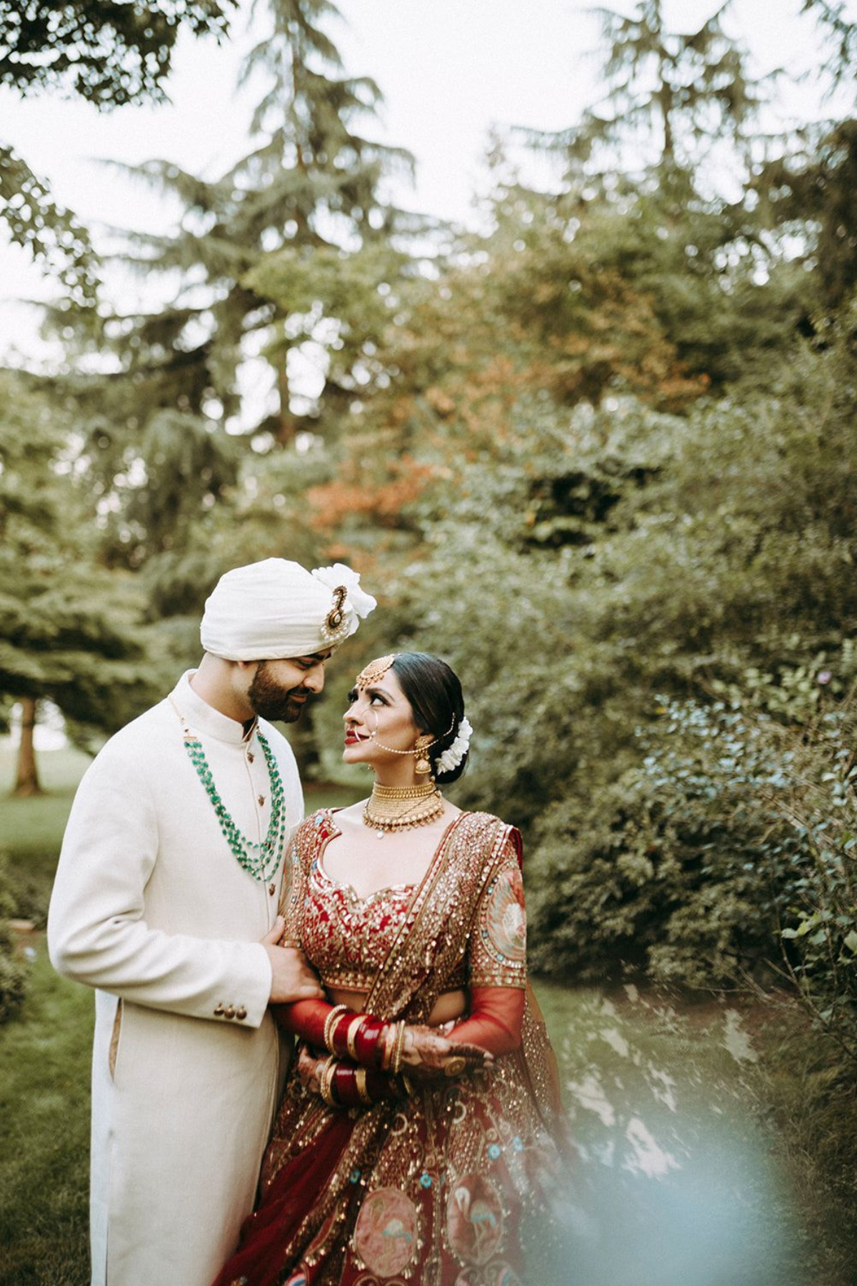 outdoor-garden-hindu-wedding-tent-greenery-bride-red-lehenga-groom