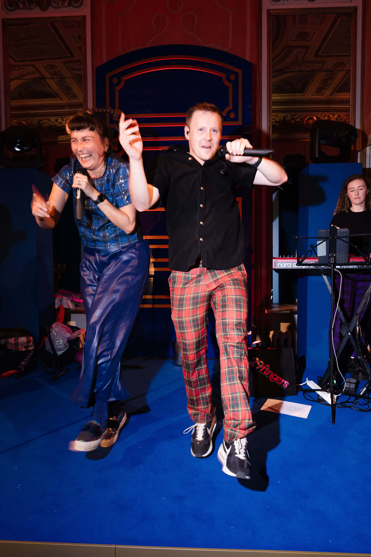 singers on a blue stage performing as part of a party band for a 50th birthday party at avington park planned by westacott weddings and events