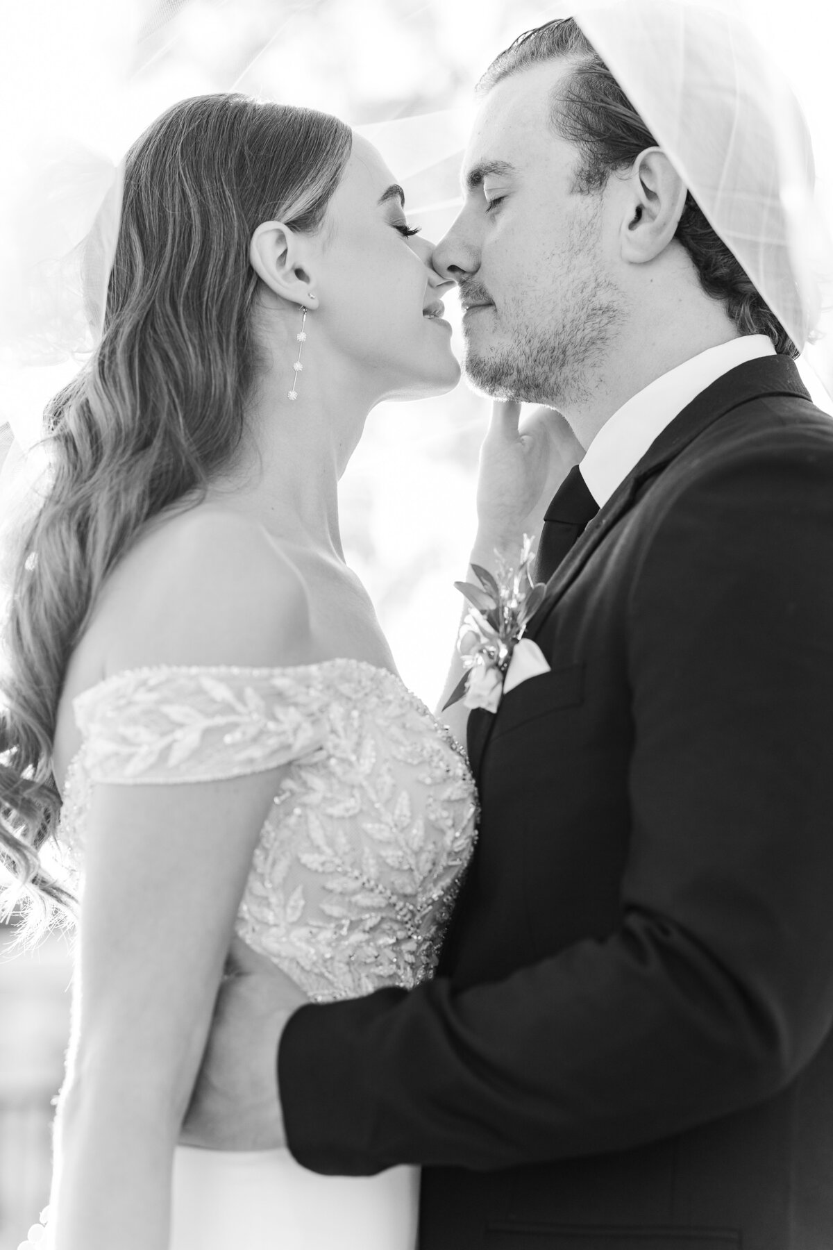 A dreamy black and white image of a bride and groom sharing a quiet moment under the veil. Captured in Westlake, this intimate portrait showcases luxury wedding photography near Fort Worth.