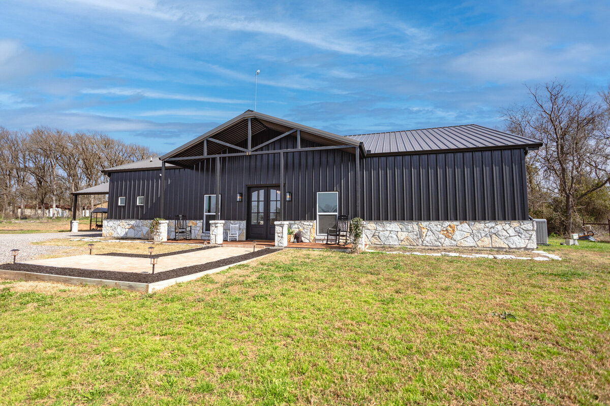 Exterior view of this five-bedroom, 3-bathroom vacation rental house for up to 10 guests with free wifi, private parking, outdoor games and seating, and bbq grill on 2 acres of land near Waco, TX.
