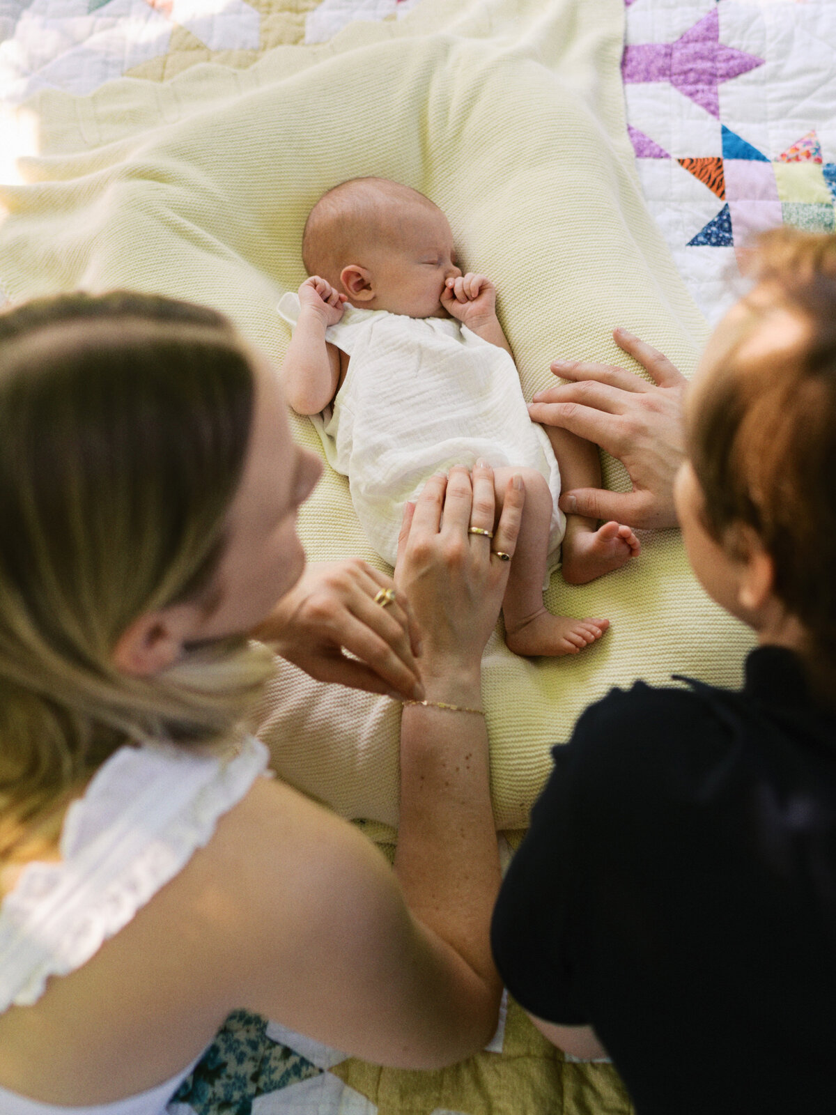 new-parents-smiling-at-baby-girl
