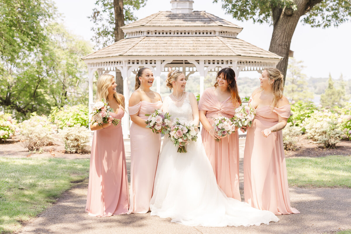 Beautiful Michigan bride having fun with bridesmaids in Saginaw Michigan.