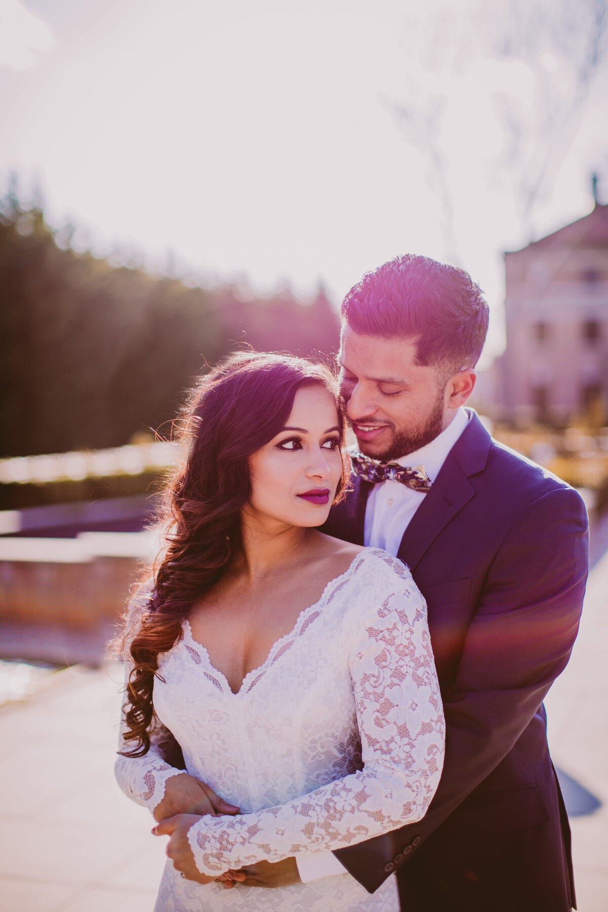 A couple sharing a moment in white dress during their engagement session at the snug harbor garden in staten island in nyc
