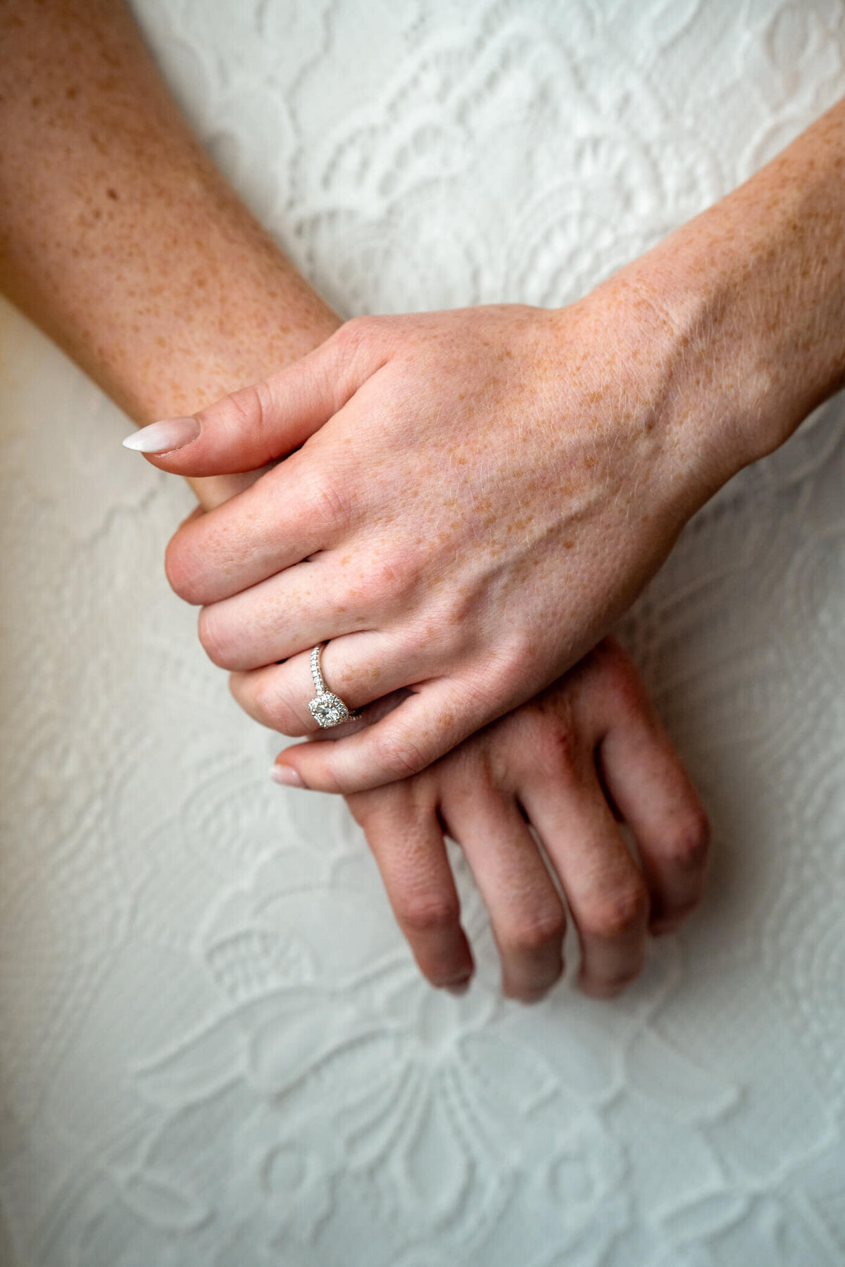 Natural light detail shot of bride clasping her hands and showing her beautiful wedding band. Captured by Pittsburgh Wedding Photographer Michael Fricke Photography.