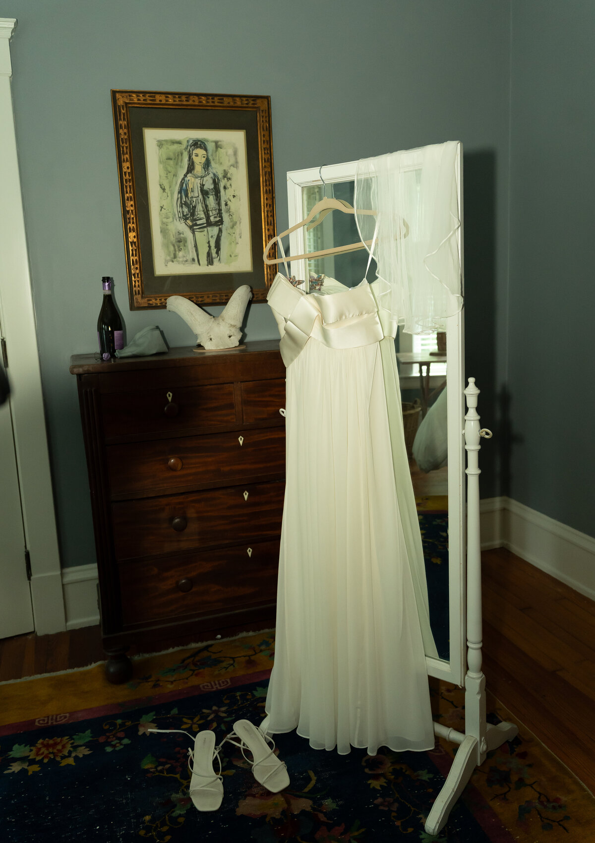 Vogue inspired editorial photo of bride's dress and accessories hanging on a mirror while getting ready for wedding in Cleveland Heights, Ohio