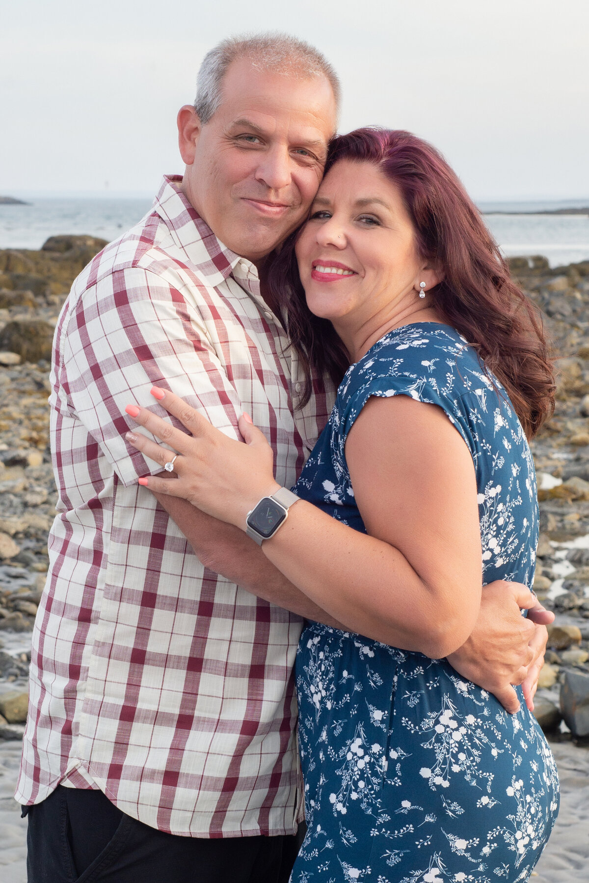 Engaged couple smiling at Fort Foster in Kittery Maine