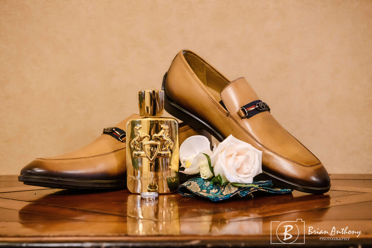 Sophisticated groom’s wedding details, including leather shoes, cufflinks, and a boutonniere.