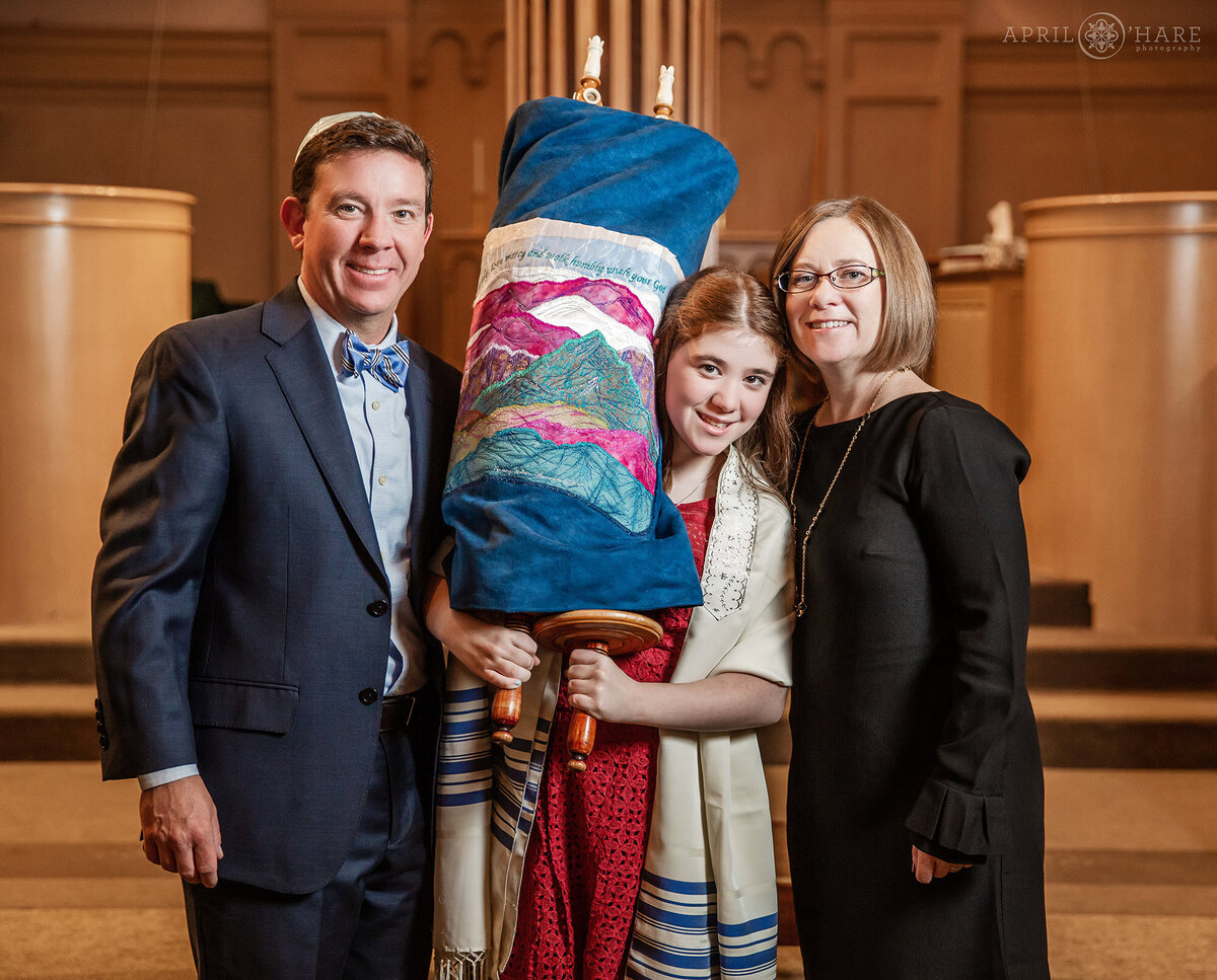 Young Woman Holding the Torah with her Parents at Temple Micah in Denver Colorado