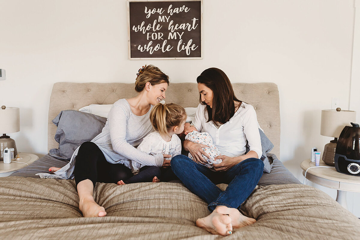 sibling kisses baby lifestyle newborn photos