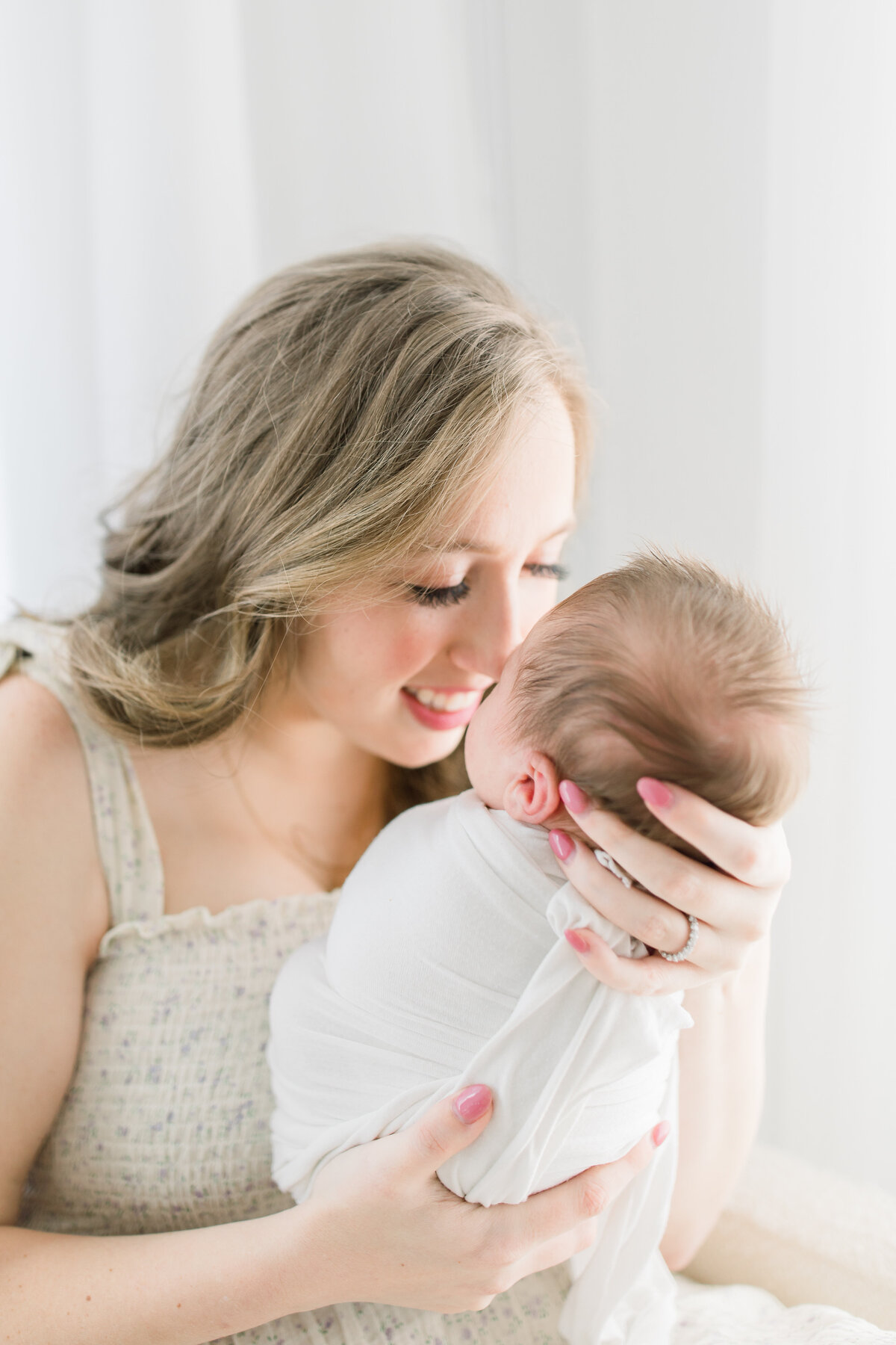 in home newborn photos atlanta - mom holding baby