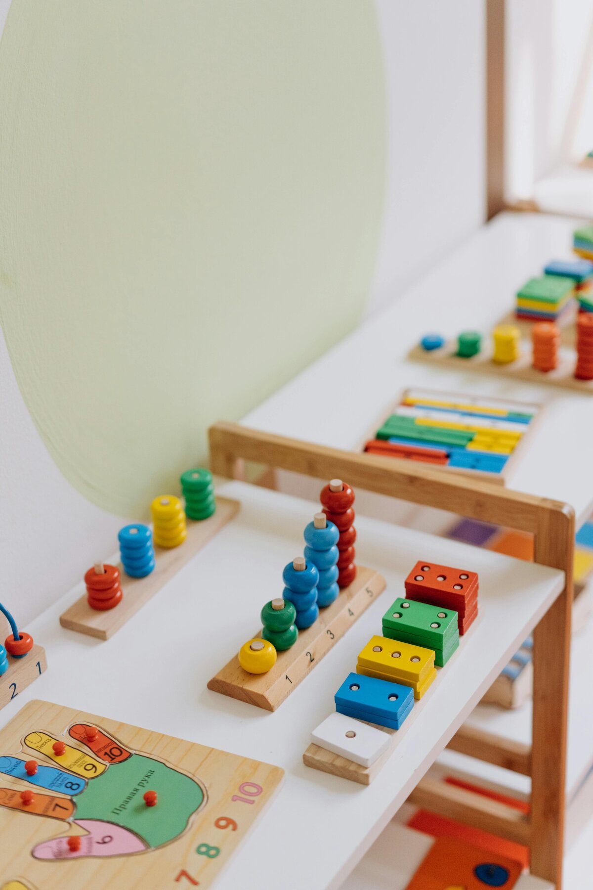 Color wooden blocks and beads neatly stacked by color and quantity on a child's activity desk