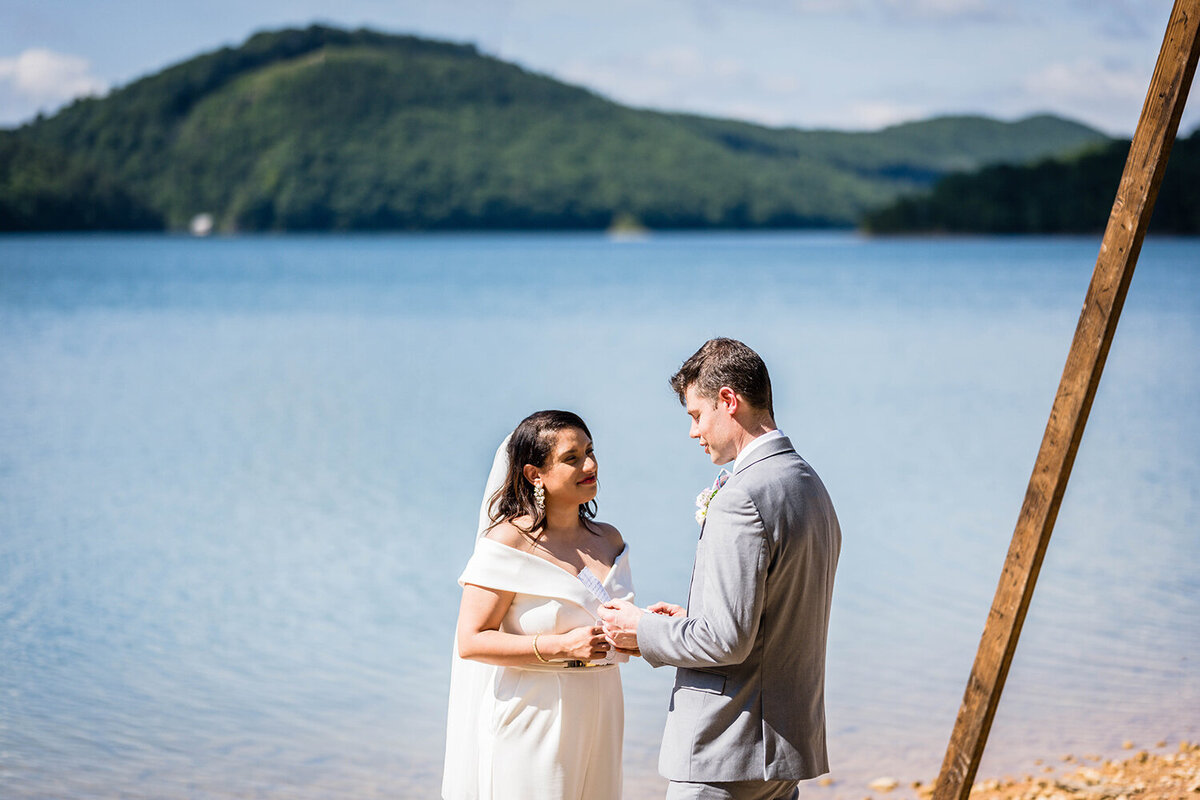 A groom reads his vows to his partner on their elopement day along the shores of Carvin’s Cove in Roanoke, Virginia.