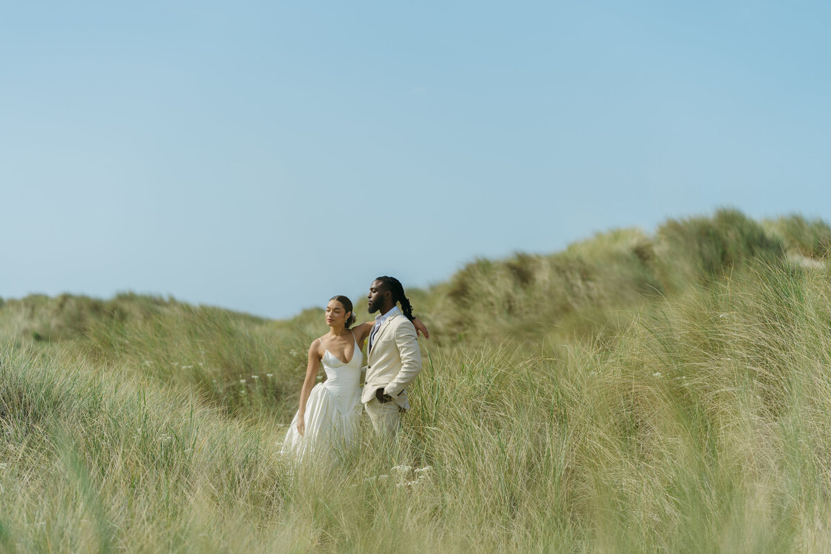 A couple stands together during their elopement at the Oregon Coast