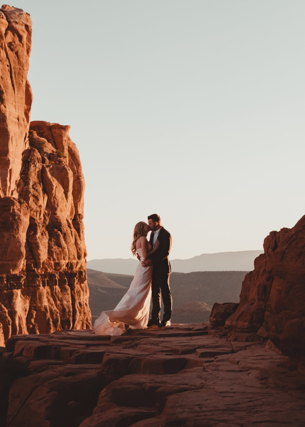 Romantic embrace on Cathedral Rock ledge Sedona taken by Kollar Photography