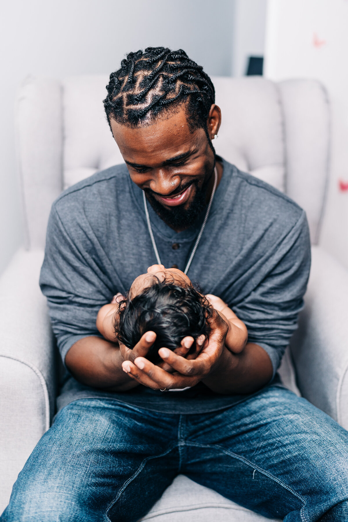 father-holding-newborn-baby-bonding-smiling
