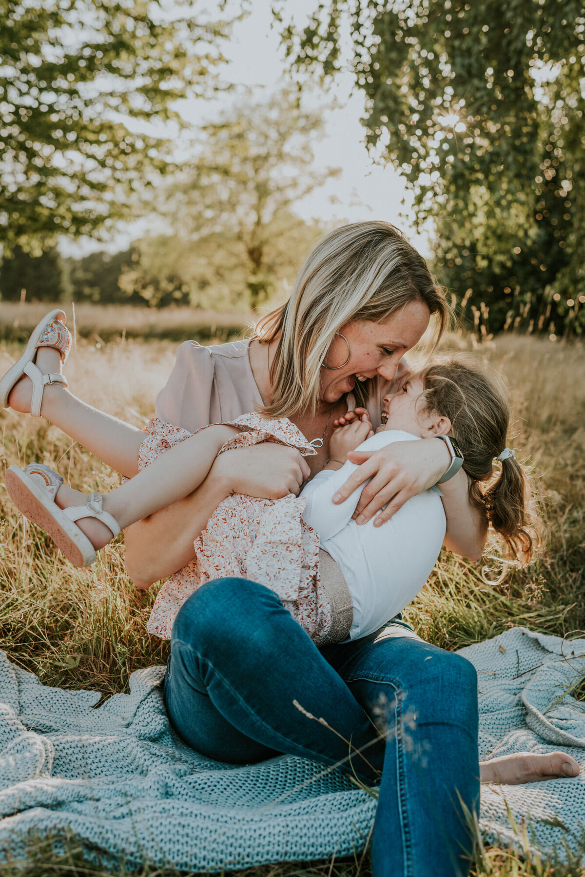 Mother holding daughter for picnic photoshoot