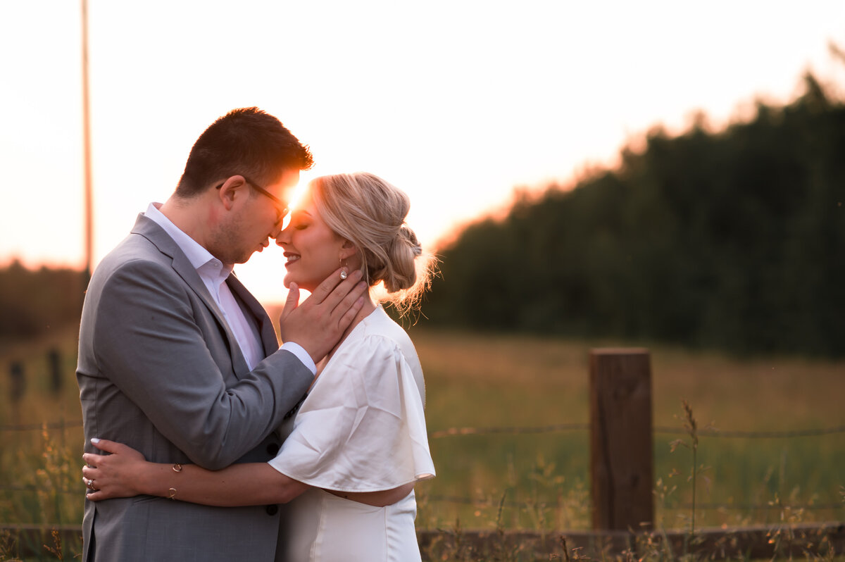 engaged couple looking at each other romantically in Edmonton, Alberta