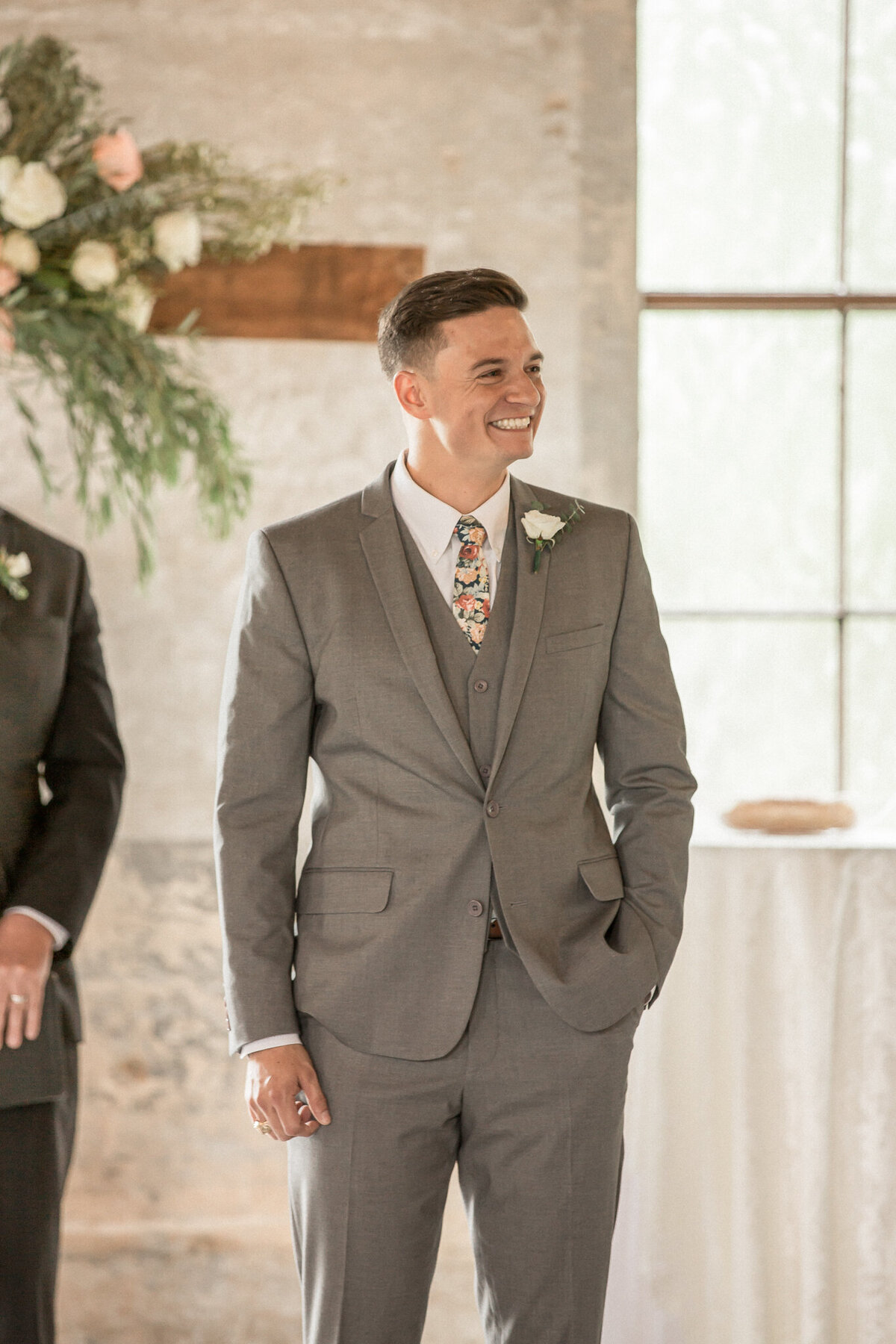 the grooms face lights up as he sees his bride entering