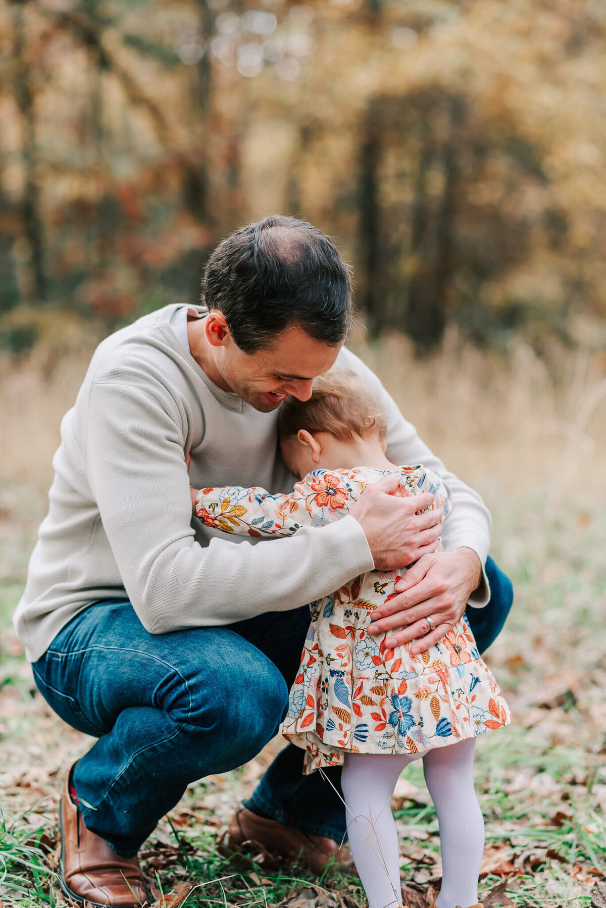 A papa getting a hug from his little daughter, taken by Denise Van a Northern Virginia family photographer