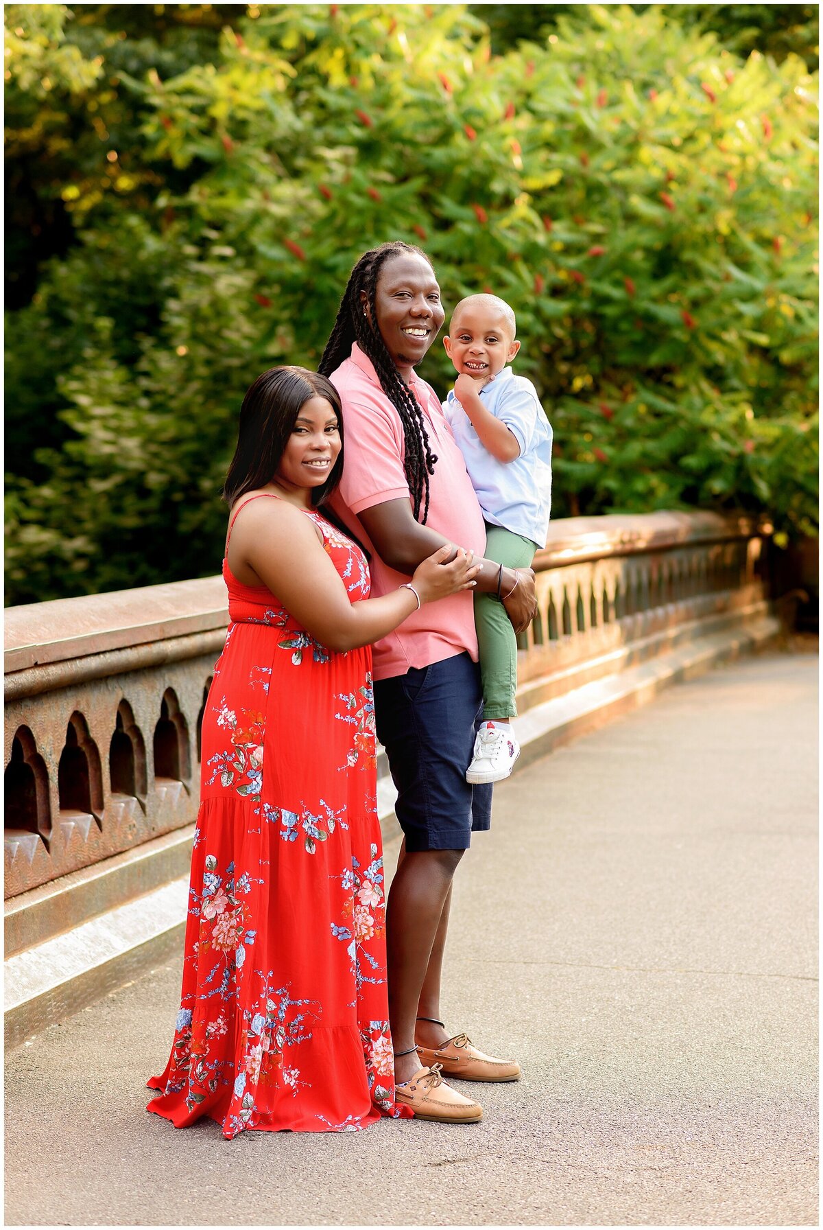 Parents holding their son up  in prospect park portrait session.