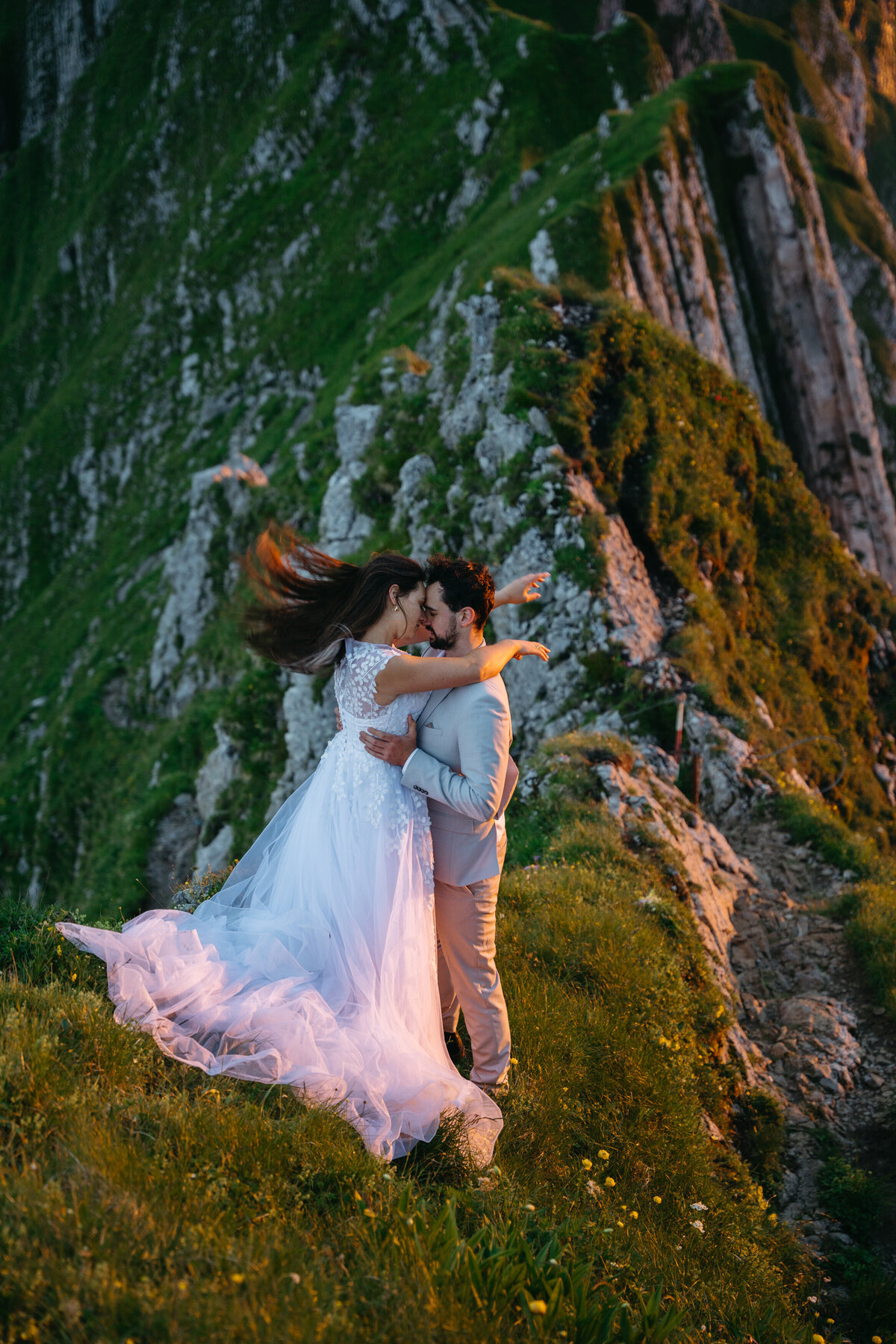 Wind picks up brides hair during sunset mountain elopement in Switzerland