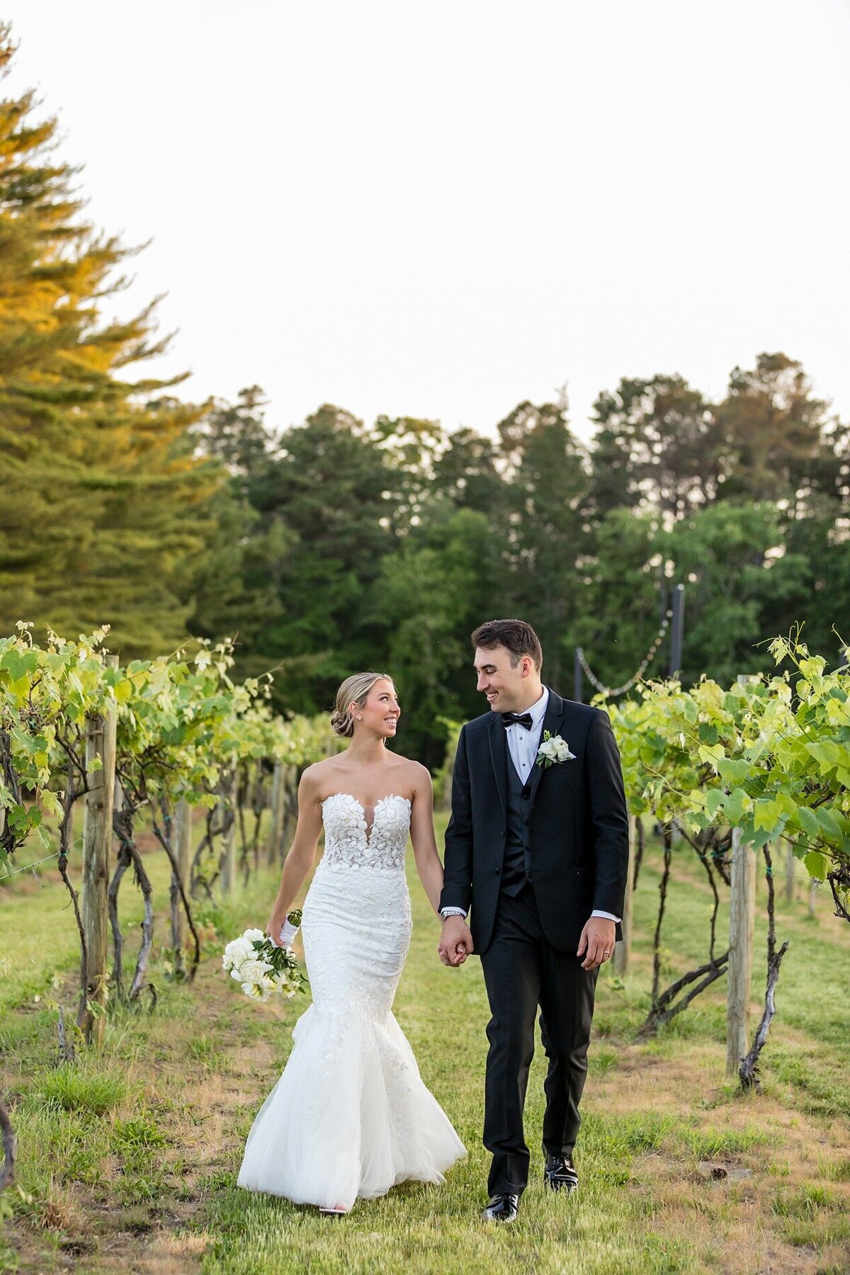 bride-and-groom-walking-renault-winery-vineyard