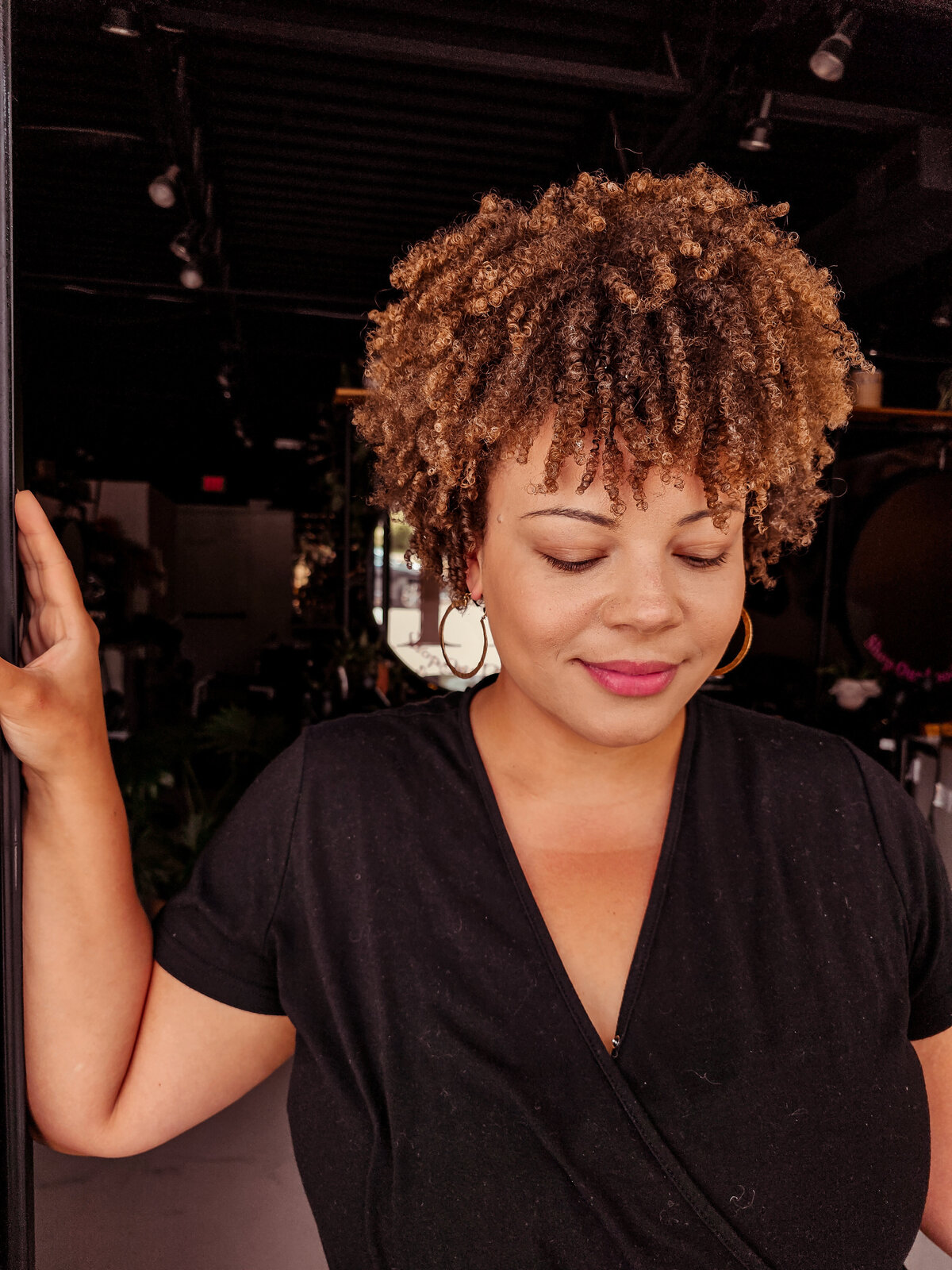 Tight coily curly hair in a sassy short hairstyle courtesy of Moxie by KC