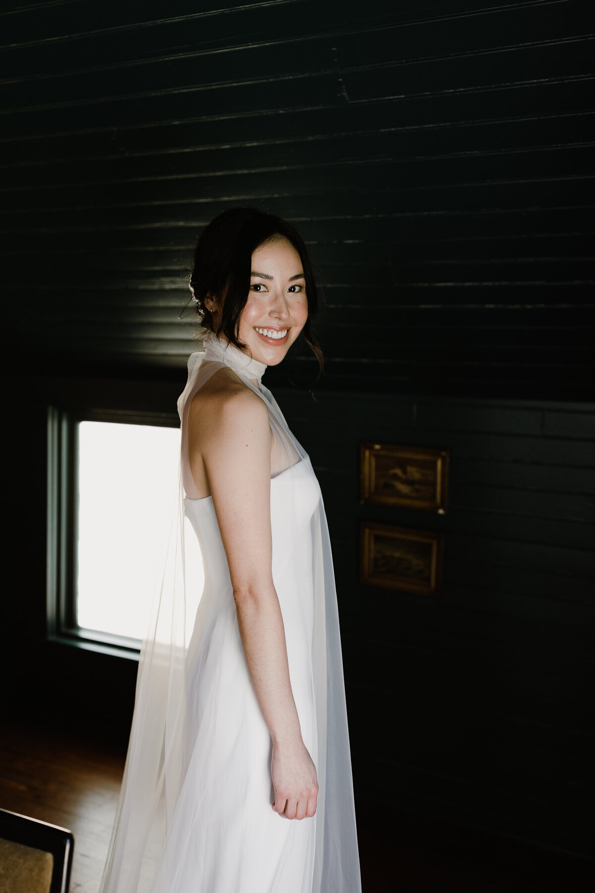 Bride wearing white dress with sheer fabric over the top at Mattie's  Austin Wedding