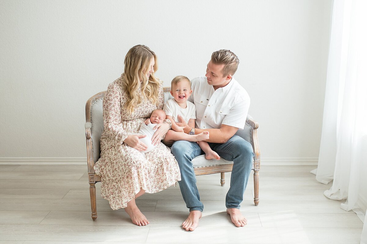 Family holding baby in Frisco Newborn Photography photoshoot