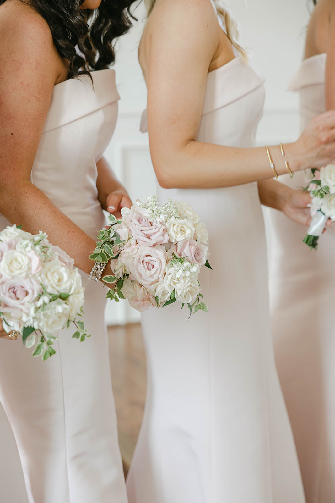 A soft pink  garden-style bouquet with a variety of flowers in a loose, organic bouquet