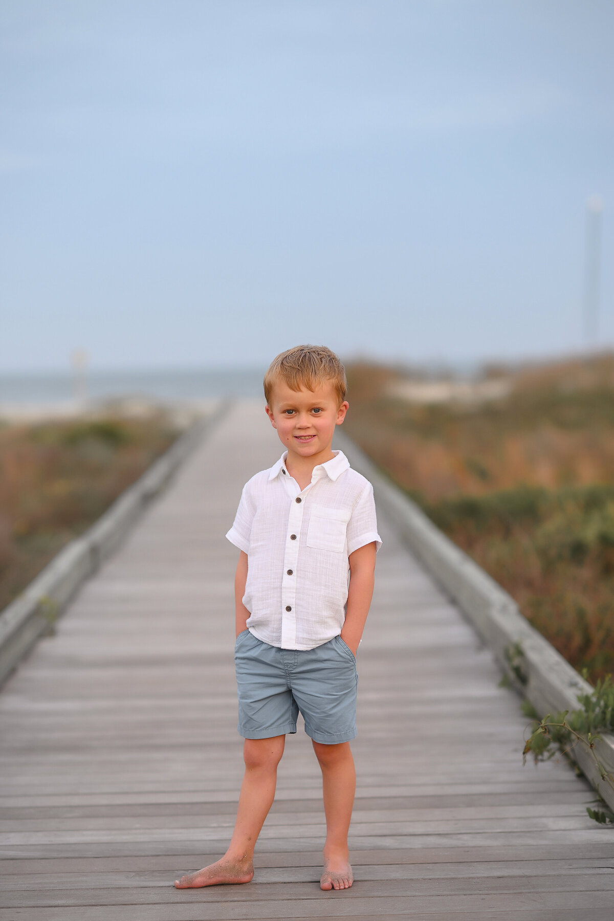 Little boy smiles into the camera during Family Photos on Isle of Palms. 