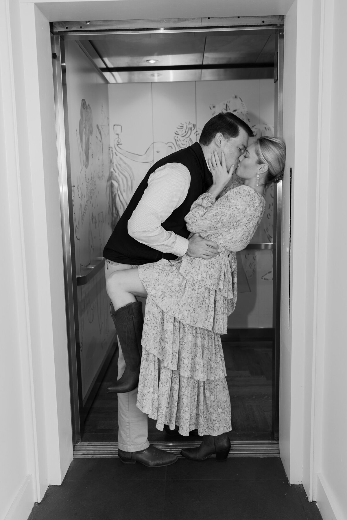 Quirk Richmond VA Photos | black and white image of couple kissing in the elevator of the Quirk Hotel in Richmond