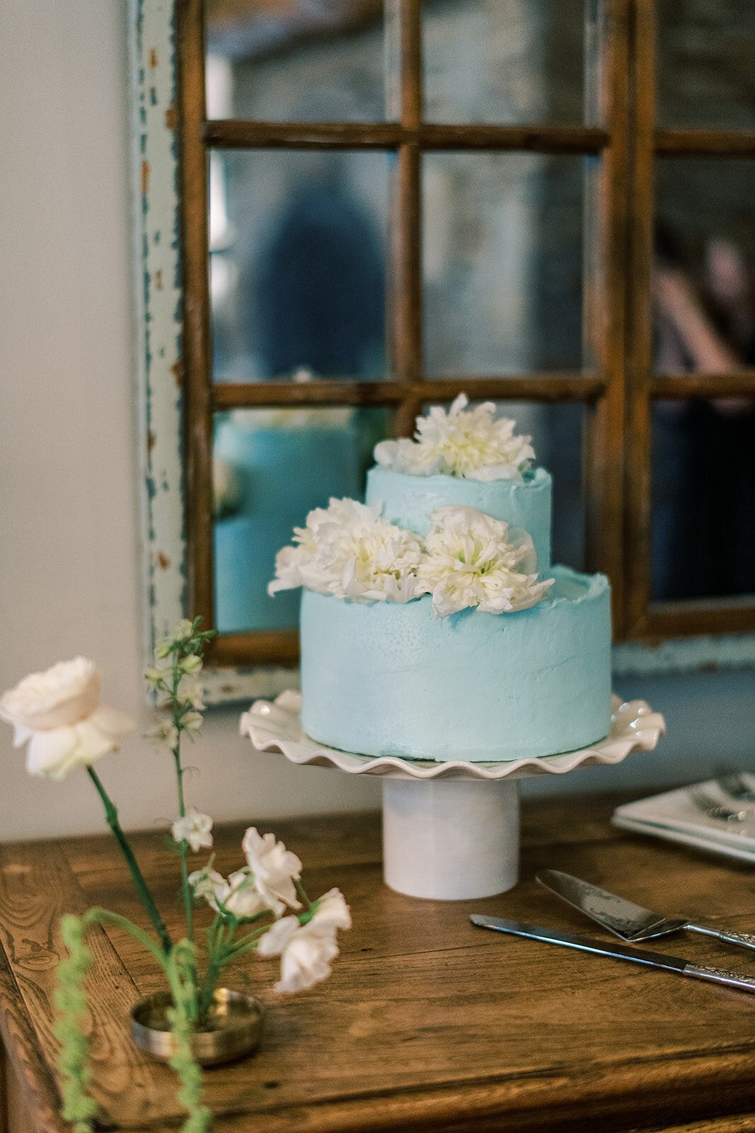  Light blue buttercream wedding cake decorated with white florals at Trillium Links & Lake Club wedding.