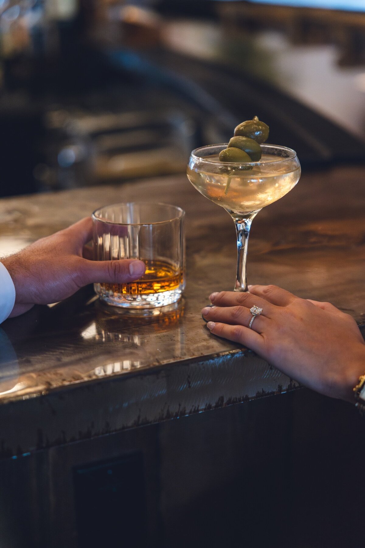 Hands toasting colorful craft cocktails at Felina bar.