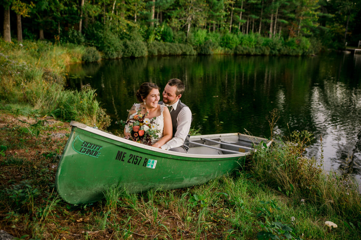 Bride and Groom sitting in canoe | Taken by Maine Wedding Photographer