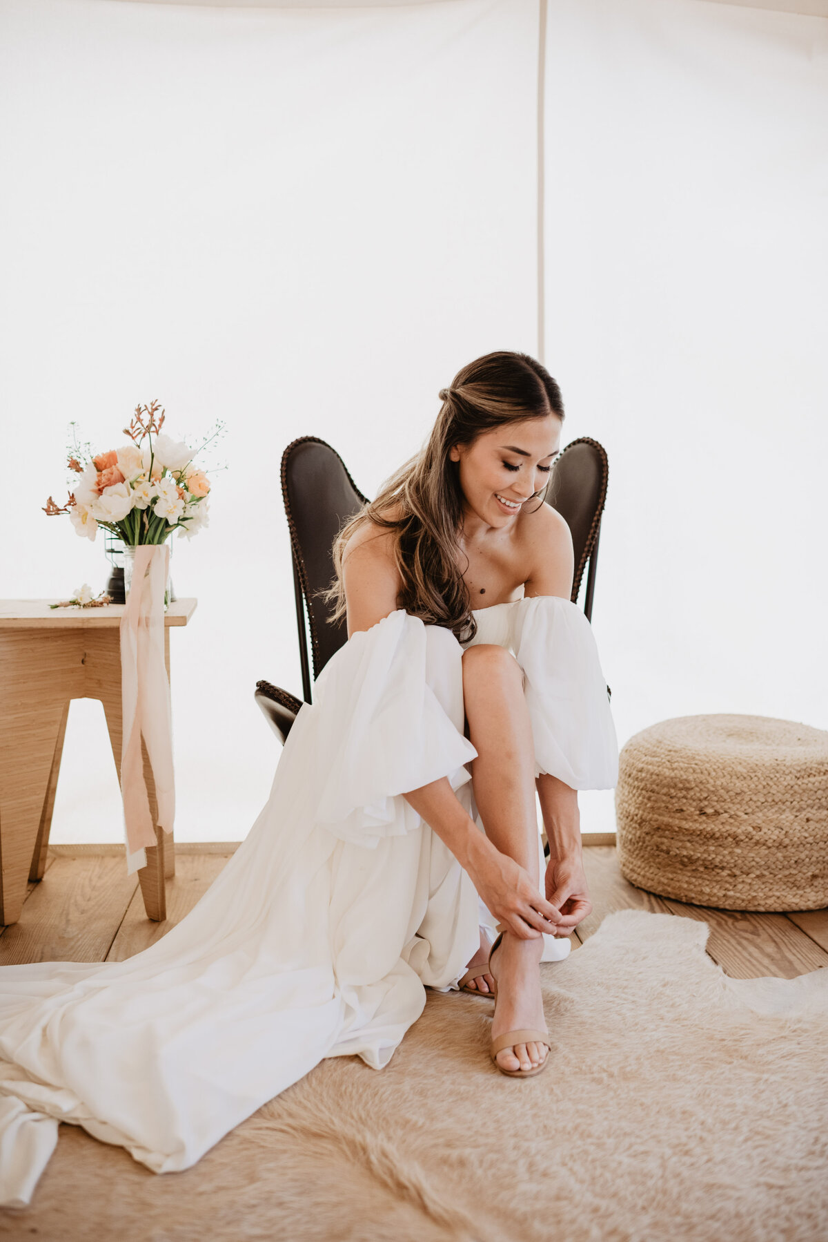 Utah Elopement Photographer captures woman putting on shoes before wedding