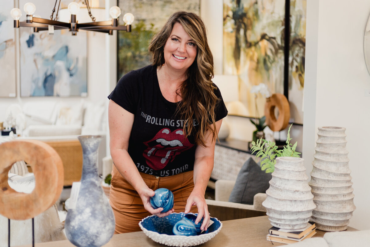 Interior Designer in showroom arranging decor