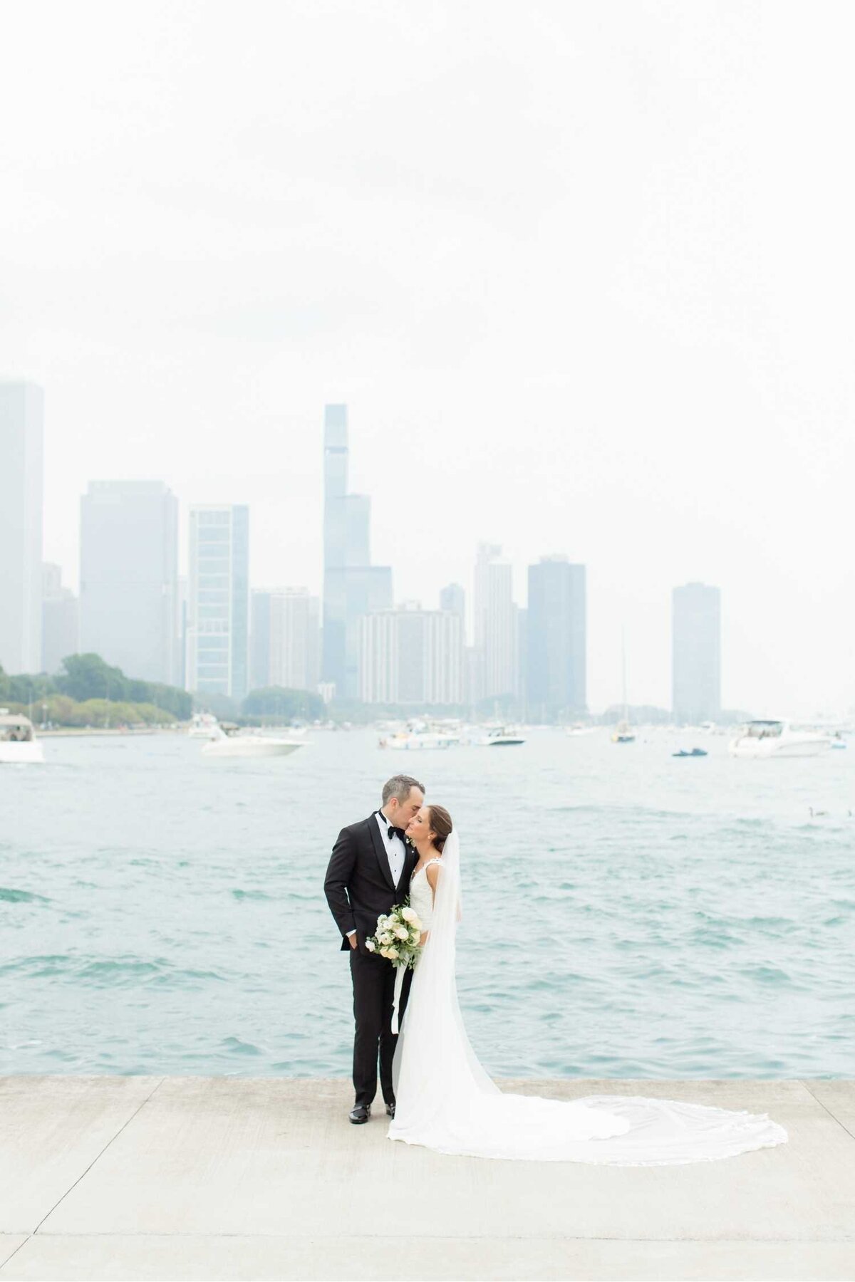 Lakefront portraits for a romantic bride and groom before their Luxury Chicago Outdoor Historic Wedding Venue.