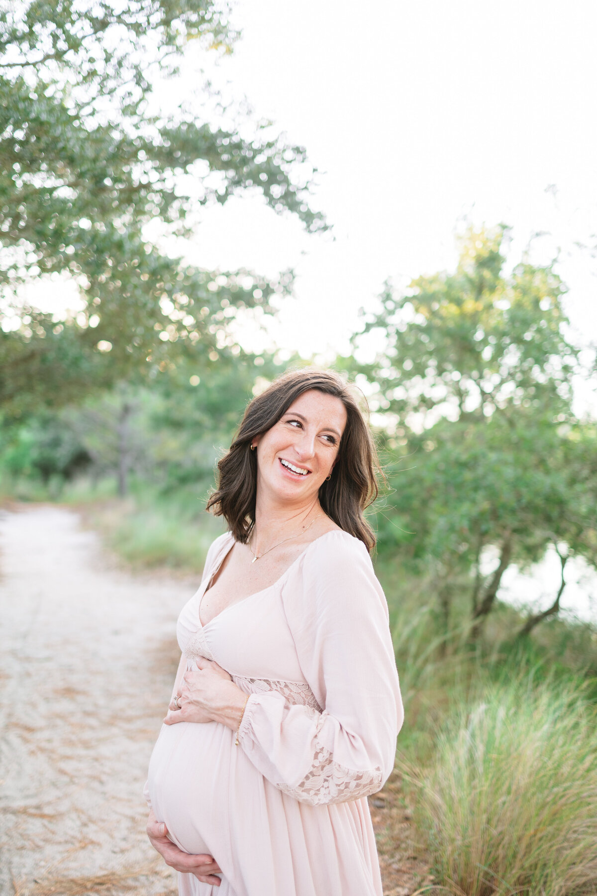 maternity-portrait-expectant-mom-laughing-during-sunset-photos-in-virginia-beach