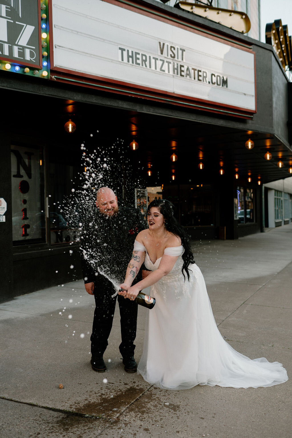 Bride and groom celebrating by popping champagne during their wedding day in New York City