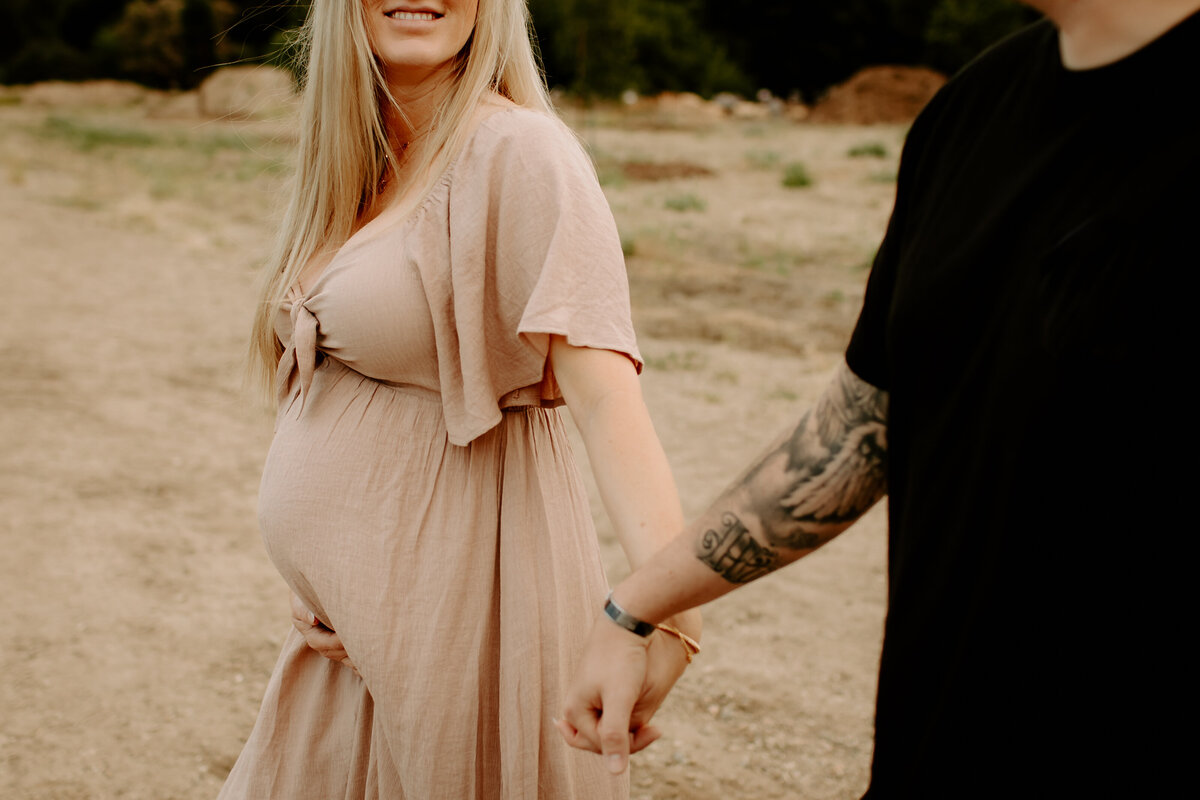 couple holding hands during maternity session in LA