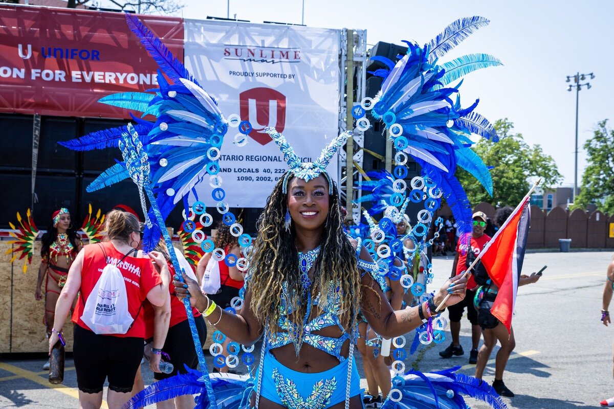 Toronto caribbean carnival parade masquerader in costume with Sunlime Mas, the number 1 medium size band at Toronto Carnival.
